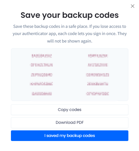 Screenshot of the Save your backup codes dialog listing single-use codes with the Copy codes, Download PDF, and I saved my backup codes buttons